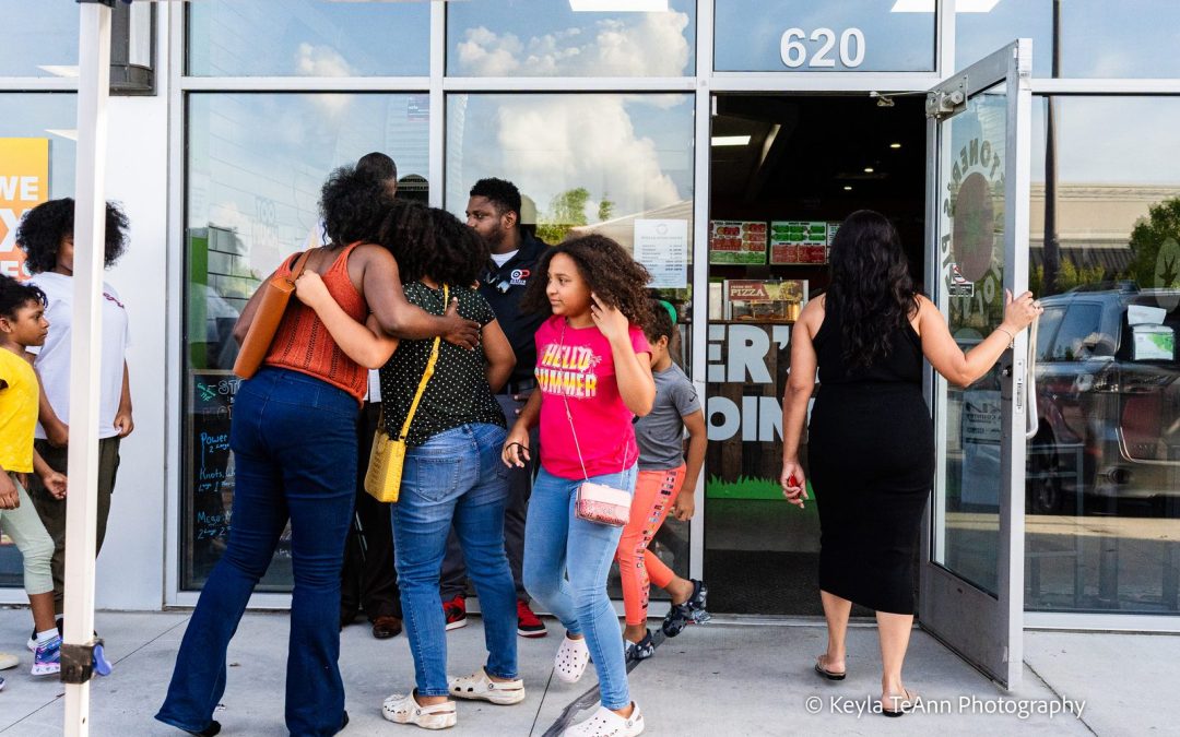 Locals arriving and hugging at the door of Stoner's Pizza Joint in Pooler for Throwback Pizza Night with Live Like Locals