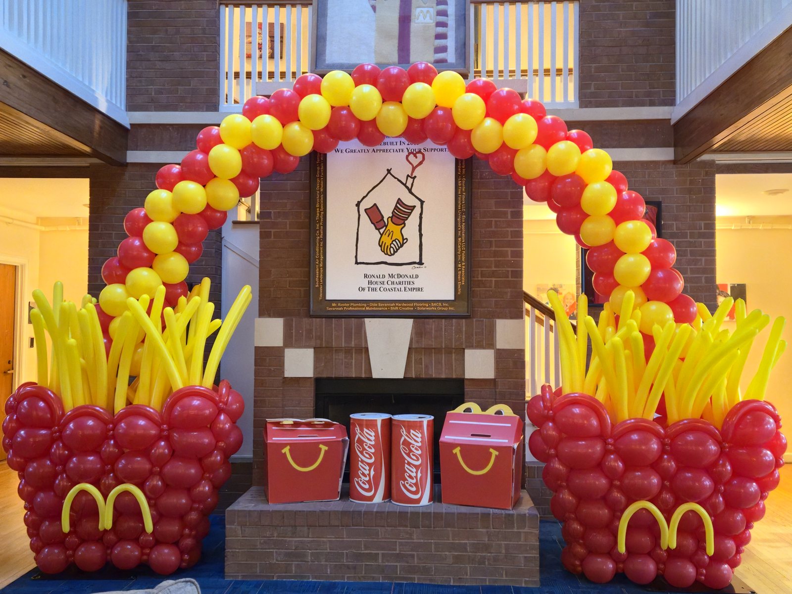 Red and yellow balloon arch with balloon french fry sculptures built for Ronald McDonald House Charities of the Coastal Empire by LJG Events