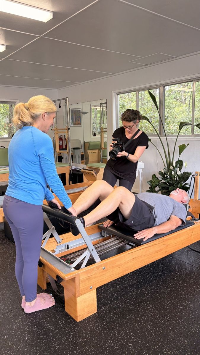 Christen Martin of Coastal Moss Creative photographing a Pilates instructor and client during a brand session in Savannah