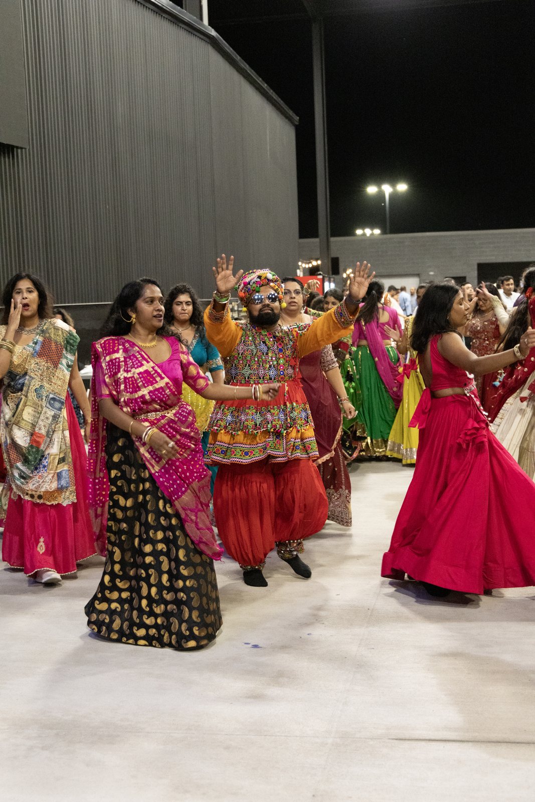 Dancers raise their hands on the Garba Festival dance floor in Port Wentworth