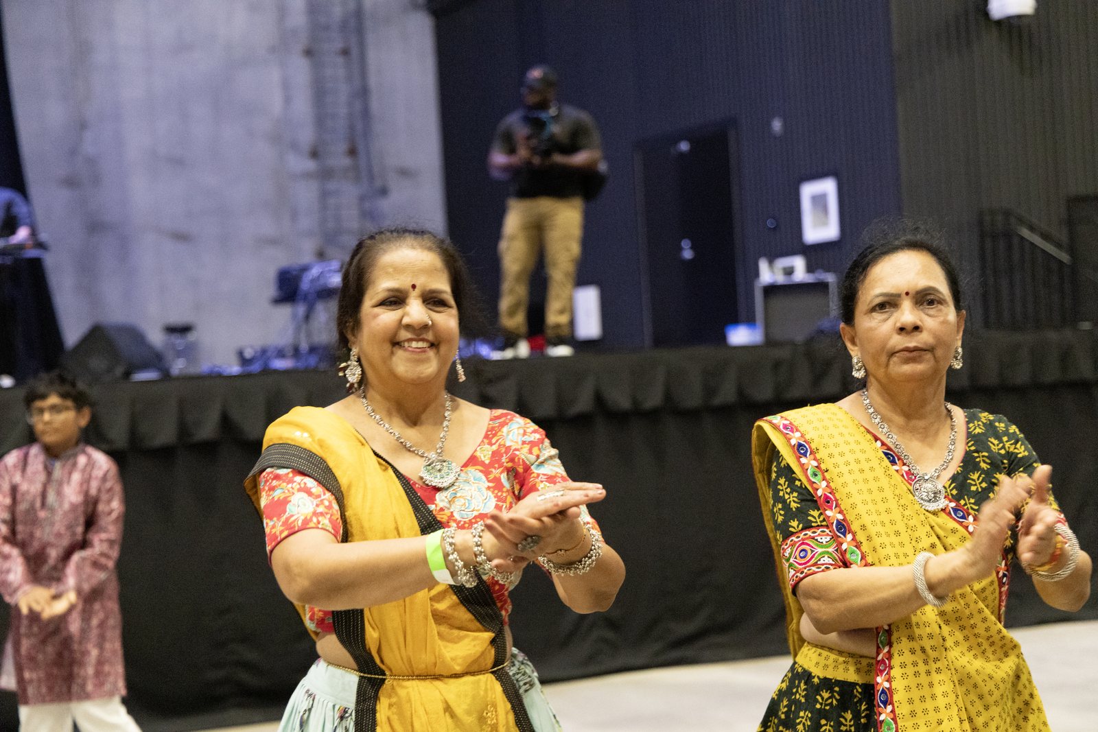 Two women smile and clap while dancing Garba in Port Wentworth